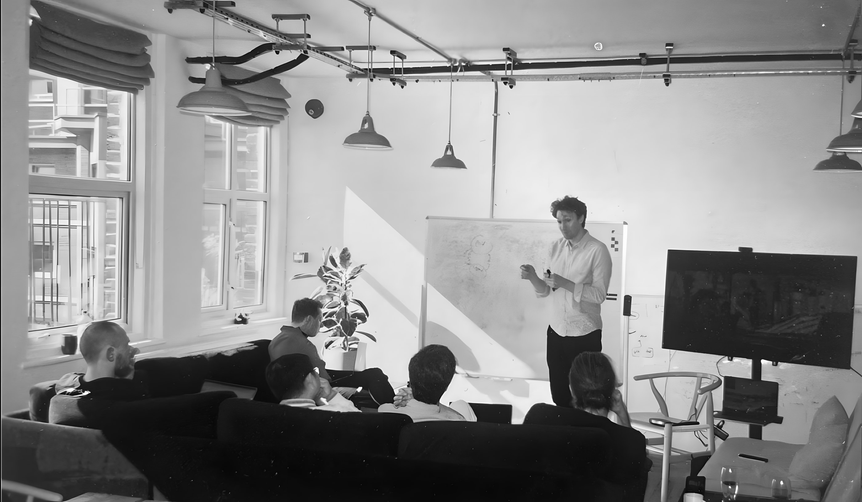 James at the whiteboard, talking the team through an idea