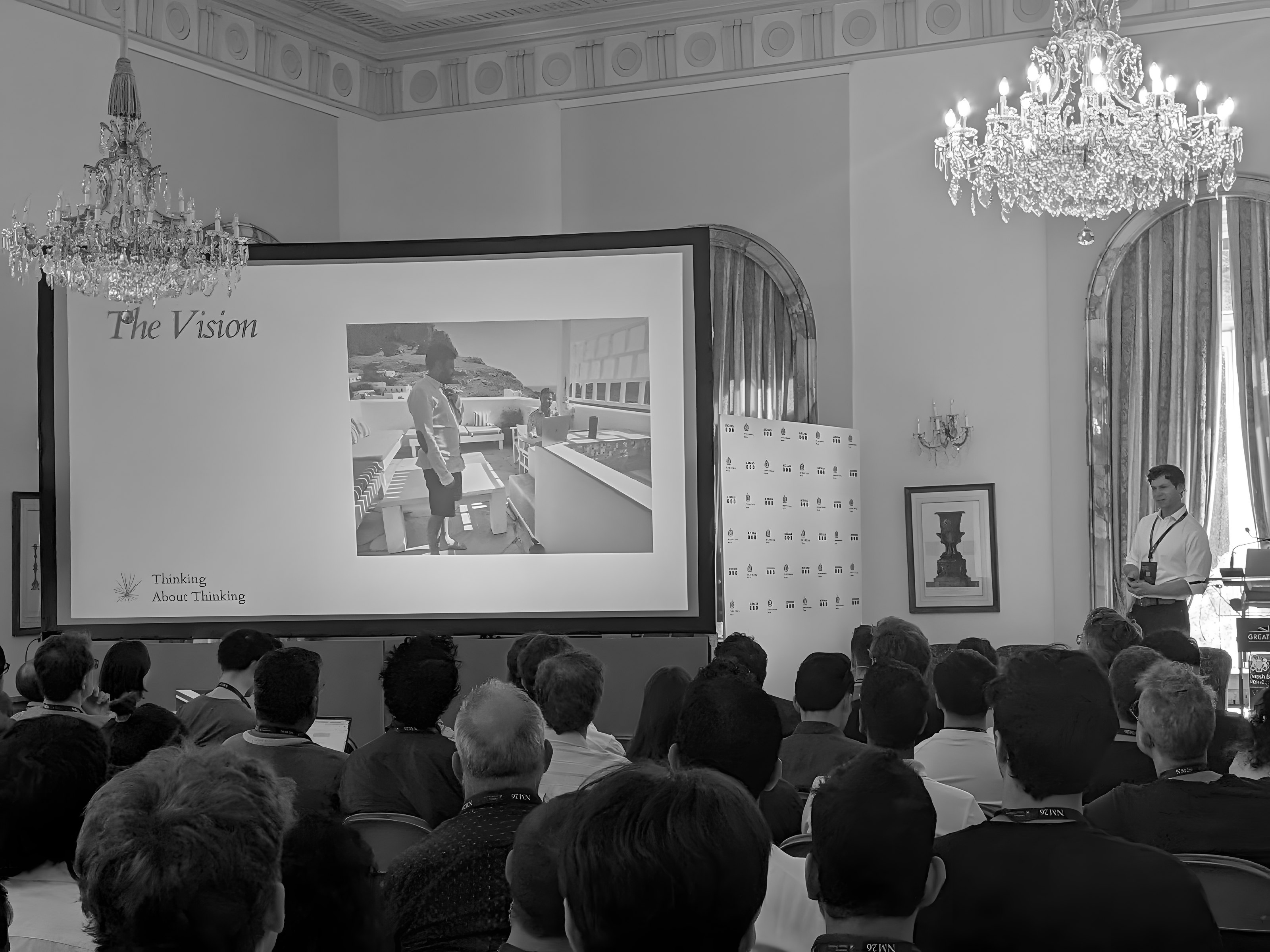 A chandelier room full of people at a Prefrontal Society talk